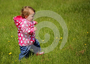 Baby girl in the park on a windy day