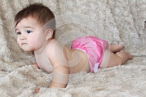 Baby girl in pink cloth diaper