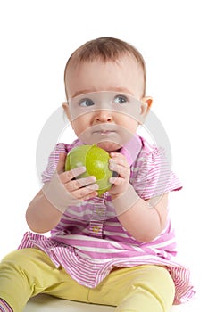 Baby girl in pink eating apple