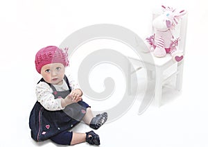 Baby girl in pink hat and toy