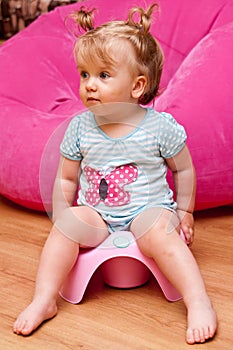 Baby girl on pink potty