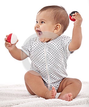 Baby girl playing with balls. photo