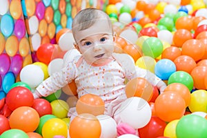 Baby girl playing with colorful balls