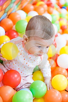 Baby girl playing with colorful balls