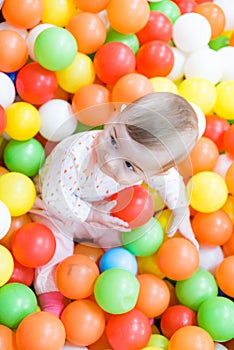 Baby girl playing with colorful balls