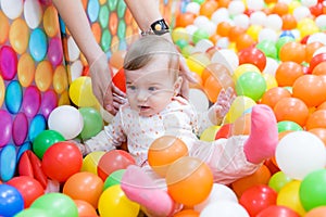 Baby girl playing with colorful balls