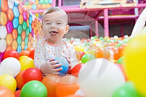 Baby girl playing with colorful balls