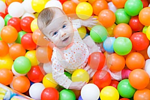 Baby girl playing with colorful balls