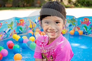 Baby girl playing in kiddie pool