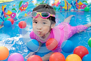 Baby girl playing in kiddie pool