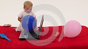 Baby girl playing with laptop