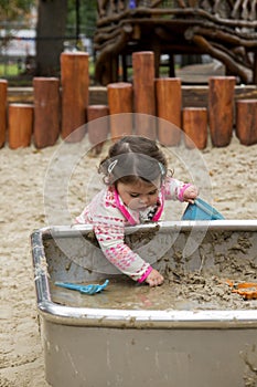 Baby Girl playing with mud