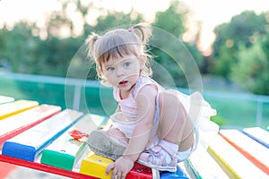 Baby girl playing in sandbox in kindergarten.ittle girl plays with toys in the sand.