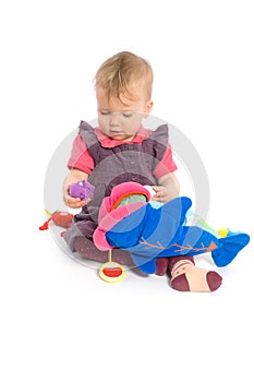 Baby girl playing with toy - isolated