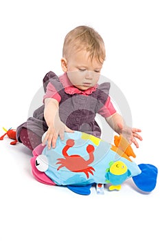 Baby girl playing with toy - isolated