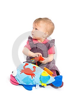 Baby girl playing with toy - isolated