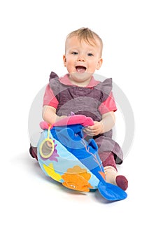 Baby girl playing with toy - isolated