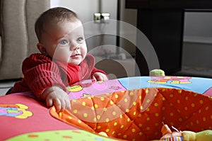 Baby girl playing with toy (playpen)