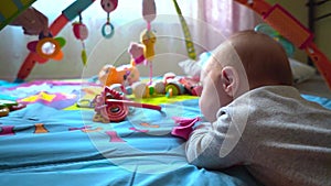 Baby girl playing with toys in bedroom. Happy family concept. Beautiful baby plays with toys indoors.