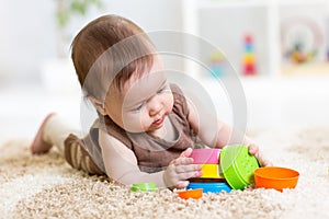 Baby girl playing with toys indoor