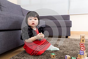 Baby girl playing wooden blocks