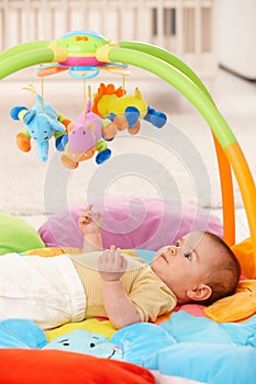 Baby girl on playmat