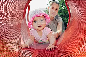 Baby Girl Plays with Mum in Playground