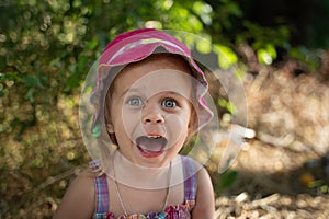 Baby girl plays in nature