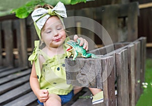 The baby girl plays with a toy frog. Selective fokus in toy frog