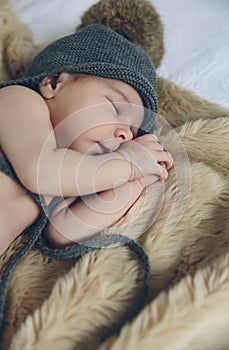 Baby girl with pompom hat sleeping