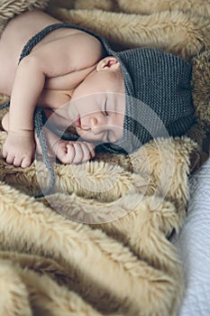 Baby girl with pompom hat sleeping