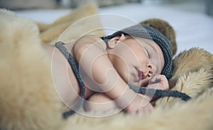 Baby girl with pompom hat sleeping