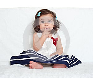 Baby girl portrait, sit on white towel