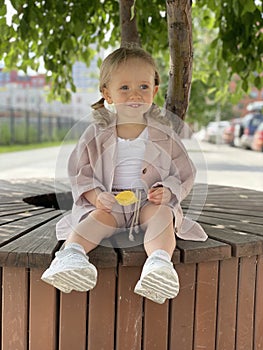 baby girl portrait sitting on the bench in