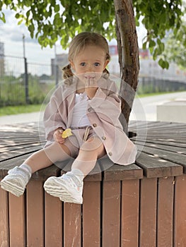 baby girl portrait sitting on the bench in