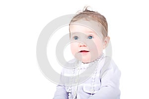 Baby girl in purple cardigan with pearl necklace