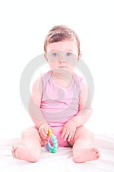 Baby girl with rattle teether toy.
