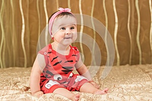 Baby girl in red with funny face