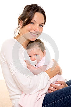 Baby girl relaxed with pacifier hug in mother arms