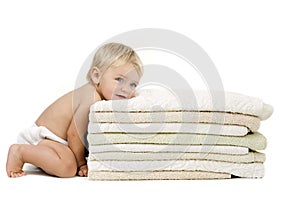 Baby girl resting head on towels