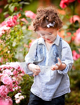 Baby girl in rose garden