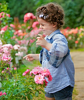 Baby girl in rose garden