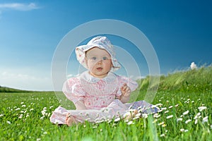 Baby girl sat in flowery field