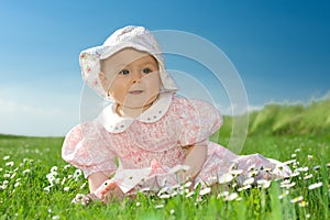 Baby girl sat in flowery field photo