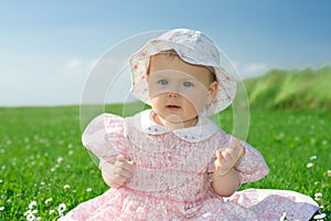 Baby girl sat in flowery field