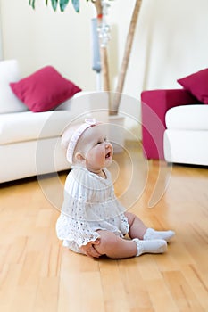 Baby girl seated on a floor