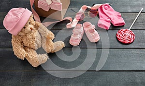 Baby girl shoes and socks on blue wooden background