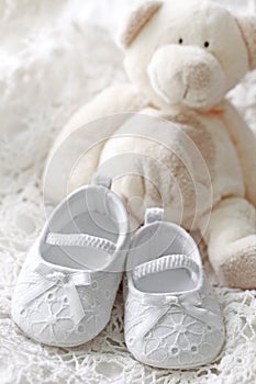 Baby girl shoes and teddy bear