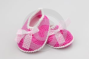 Baby girl shoes on white background, banner, copy space. Knitted baby booties