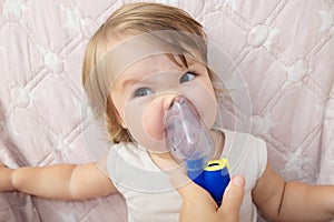 Baby girl sick and don`t want to use nebulizer mask making inhalation, respiratory procedure by pneumonia or cough for child